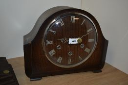 A 1940's oak cased Westminster Chime mantel clock, of arched form with Roman hours to the chapter