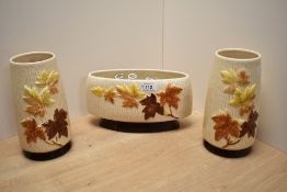 Three 1960s Sylvac Autumn Leaves patterned vases, to include a pair of cylindrical tapering vases