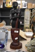 A 20th Century African carved hardwood sculpture of an indigenous woman, measuring 50cm high