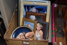 An assortment of Marilyn Monroe memorabilia consisting of pictures and prints, display plates and