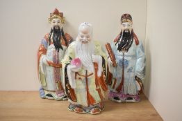 A group of three 20th century Chinese pottery immortals, each decorated in polychrome and