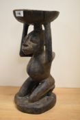 An African carved tribal hardwood caryatid stool, possibly Luba,from Congo (DRC) modelled as a