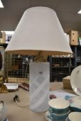 An attractive glass table lamp, of cylindrical form and decorated with white opaque swirls, 33cm
