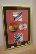 A limited edition Beatles 1962-1966 CD plaque under glass, measuring 50cm x 35cm overall.