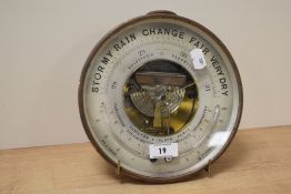 An early 20th century French made brass-cased combination barometer/thermometer, of circular form
