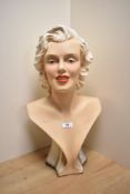 A cast and painted pottery bust of Marilyn Monroe, 51cm high some flaking and paint losses