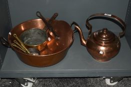 A 19th century copper kettle, having a pivoted over handle and stepped circular cover, sold together
