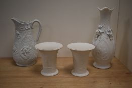 A pair of Continental bisque porcelain vases, of flared cylindrical form, decorated with repeating