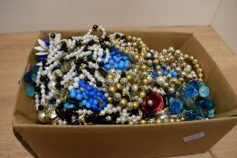 A large assortment of beaded necklaces and costume jewellery including brooches