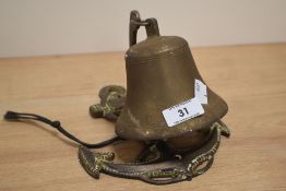 A vintage cast-brass maritime/nautical themed bell, with rope and anchor shaped bracket 19cm