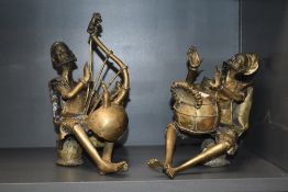 A pair of Nigerian (Benin) brass musician figures, one seated the other modelled playing a harp type