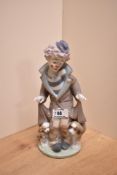 A Lladro porcelain clown group 'Suprise' number 5091, modelled as a forlorn clown revealing a dog