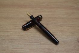 A Parker Duofold Deluxe Junior button fill fountain pen in rose and black with two narrow and one