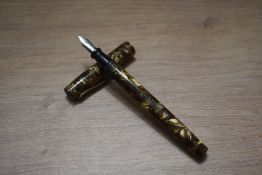 A Wasp Clipper lever fill fountain pen in gold and brown marble with single cap band having Sheaffer