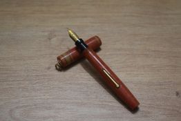 A Mabie Todd & Co lever fill pocket fountain pen and propelling pencil set in pink woodgrain with