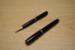 A Parker Duofold Special Short button fill fountain pen and propelling pencil in black with two
