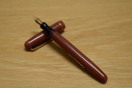 A Mabie Todd & Co Swan 3173 self filler lever fill fountain pen in coral with one narrow band to the