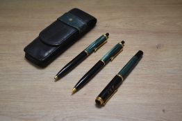A Pelikan 400 fountain pen, ballpoint pen and propelling pencil set in green and black. Engraved