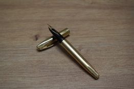 A Sheaffer Legacy converter fill fountain pen in gold plate parallel line pattern having Sheaffer