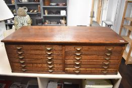 An oak chest of twelve pen collectors drawers each drawer 49x42cm, overall the chest is 108cm
