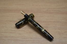 A Parker Duofold Special button fill fountain pen in green black marble with two narrow and one