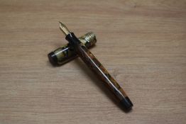 A Parker Duofold Lucky Curve Deluxe Senior button fill fountain pen in black and pearl with three