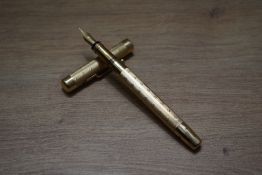 A Mabie Todd & Co Swan twist fill fountain pen in gold having Swan 2H 14ct 585 England nib