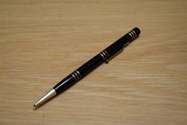 A Mabie Todd & Co Fyne Poynt propelling pencil set in black with several decorative bands.