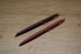 Two Parker Classic ballpoint pens in matte finish. One has crack to top
