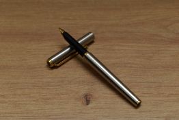 A Parker Arrow aerometric fountain pen in brushed steel with gold trim.