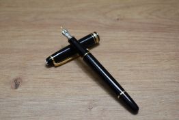 A Montblanc 144 Classique converter fill fountain pen in black with two narrow and one broad cap
