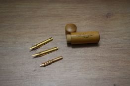 A screw top wooden case marked Gold Pens Mabie Todd & Bard 93 Cheaside London containing three nibs.