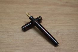 A Parker Duofold Special Streamlined Short button fill fountain pen in rose and black with two cap