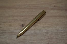 A Sheaffer Legacy propelling pencil in gold plate parallel line pattern.