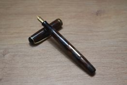 A Burnham unmarked lever fill fountain pen of small proportions in grey gold and brown swirl with