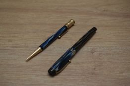 A Parker Duofold Special Steamlined Short button fill fountain pen and propelling pencil in blue and
