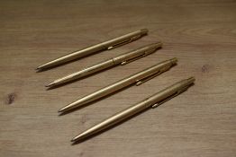Four Parker Classic rolled gold ballpoint pens in various design