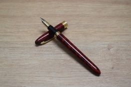 A Sheaffer Crest converter fill fountain pen in red and black with gold plated band to cap having