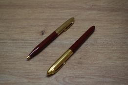 A Sheaffer Crest converter fill fountain pen and ballpoint pen set in red with gold plated cap