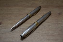 A Montblanc Meisterstuck piston fill fountain pen and propelling pencil in 925 silver with gold trim