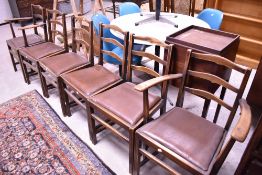 A set of six (four plus two) early 20th Century oak ladder back dining chairs