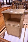 A vintage woven fibre bedside cabinet in the Lloyd Loom style, gold coloured