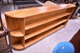 A vintage pine shallow bookshelf, width approx. 204cm