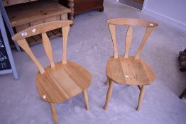 A pair of beech kitchen chairs, in the Arts and Crafts style, labelled for HJ Berry