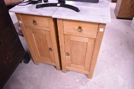A pair of natural pine bedside cabinets with marble tops, height approx. 80cm
