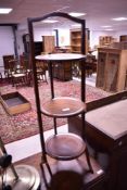 An early 20th Century mahogany folding cake stand
