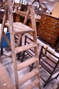 A set of vintage wooden stepladders