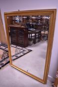 A modern gilt effect wall mirror, approx. 105 x 136cm