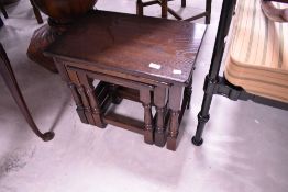 A Priory style oak nest of three tables