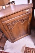 A traditional oak corner cupboard base